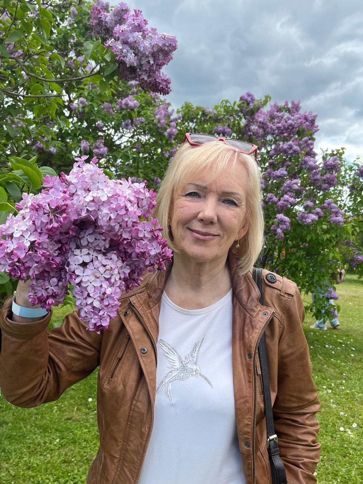 grannie with glasses holding flower