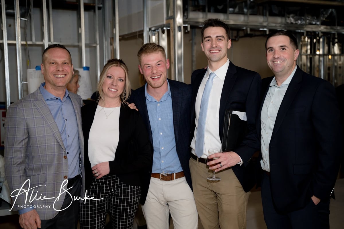 Members of The One Hundred Club touring newly renovated space with wine lockers and lounge seating