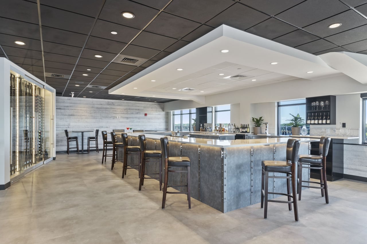 Interior of The One Hundred Club’s modern bar area completed by Jewett Construction.