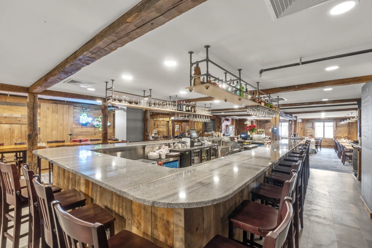 Rustic-style bar interior with granite countertop at Ricetta’s Brick Oven Ristorante, completed by Jewett Construction