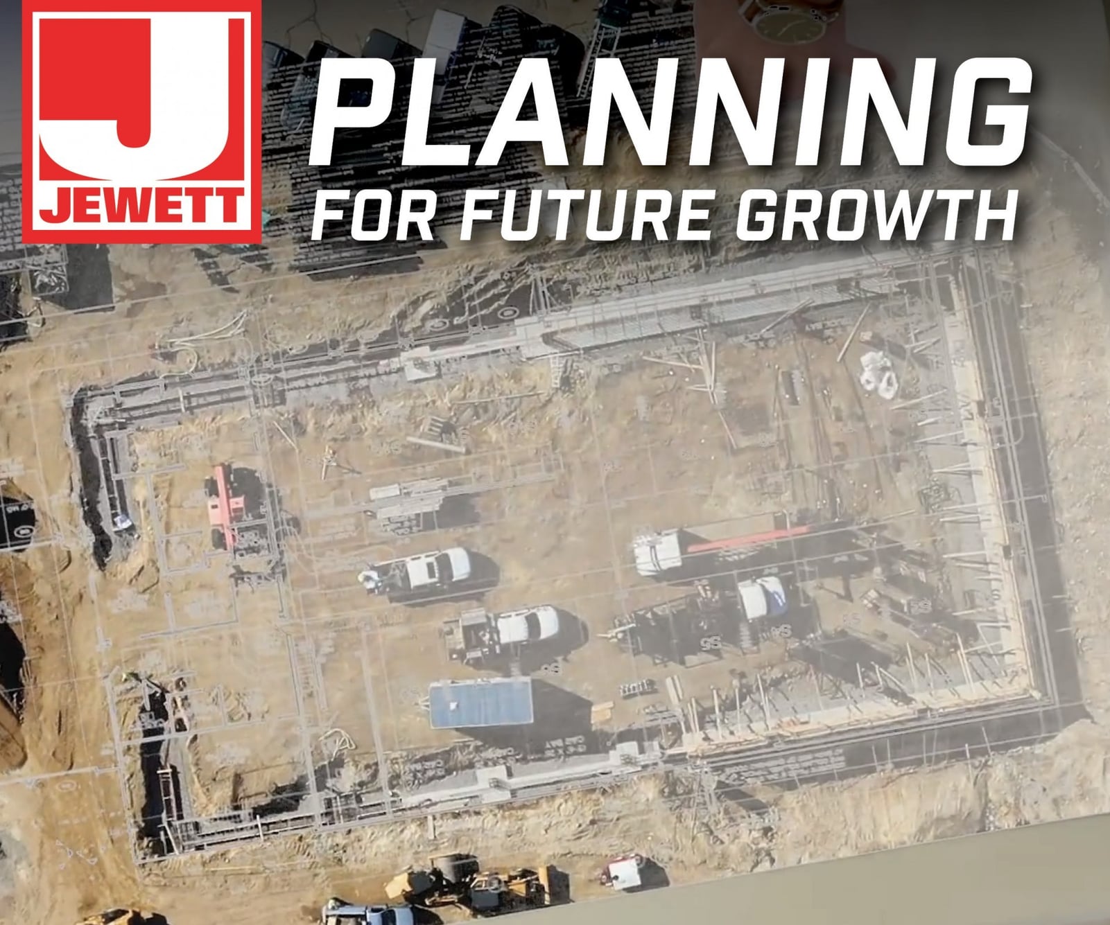 Aerial view of an active construction site showing foundations, heavy machinery, and vehicles. The Jewett Construction logo and the phrase “Planning for Future Growth” are overlaid.
