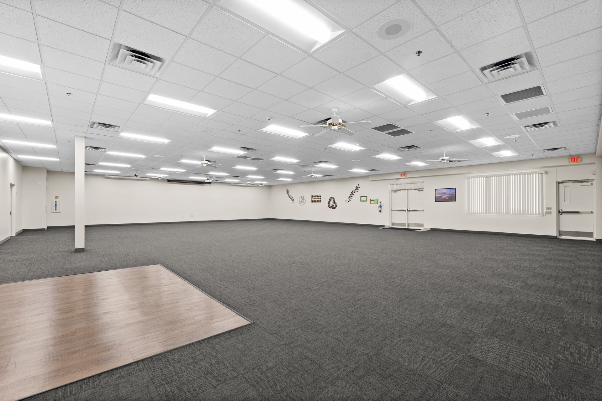Large capacity event room with projection-ready ceiling, ample lighting, and wall space for banquets and presentations.