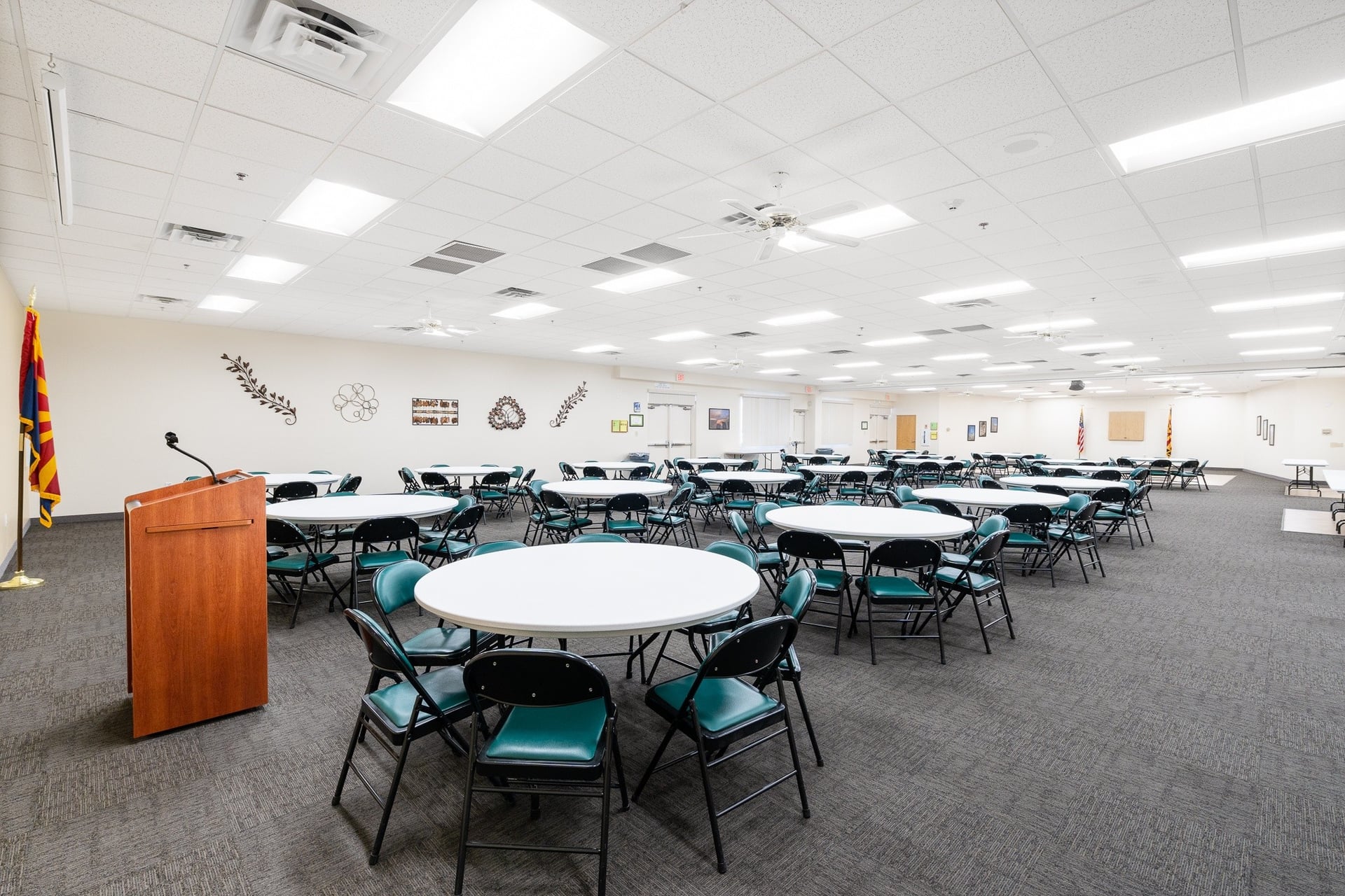 Large banquet and meeting room at Sun City West Foundation set with round tables and chairs, ready for a community gathering.