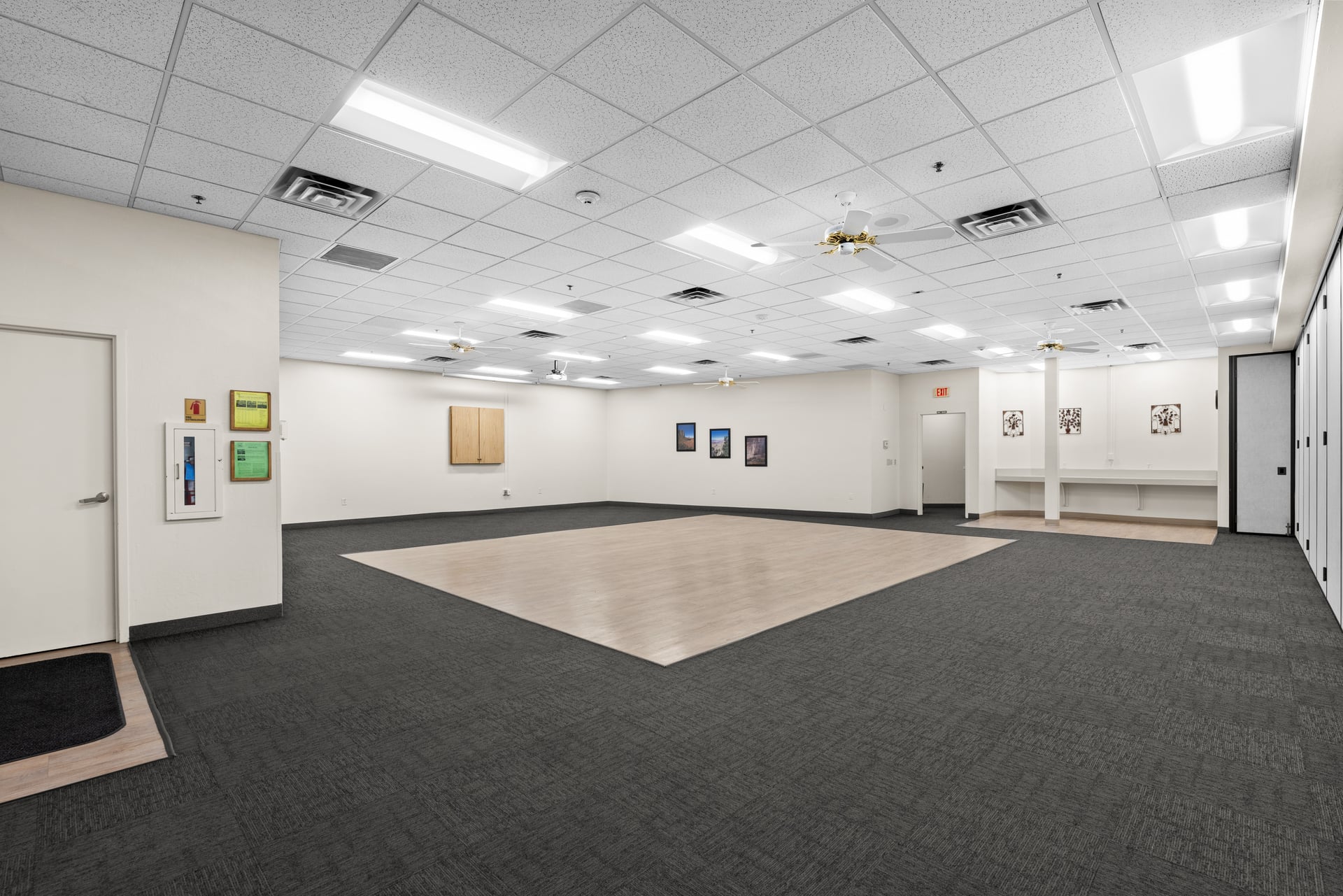 Warm and flexible meeting space with defined dance floor area and ample seating capacity for social events.