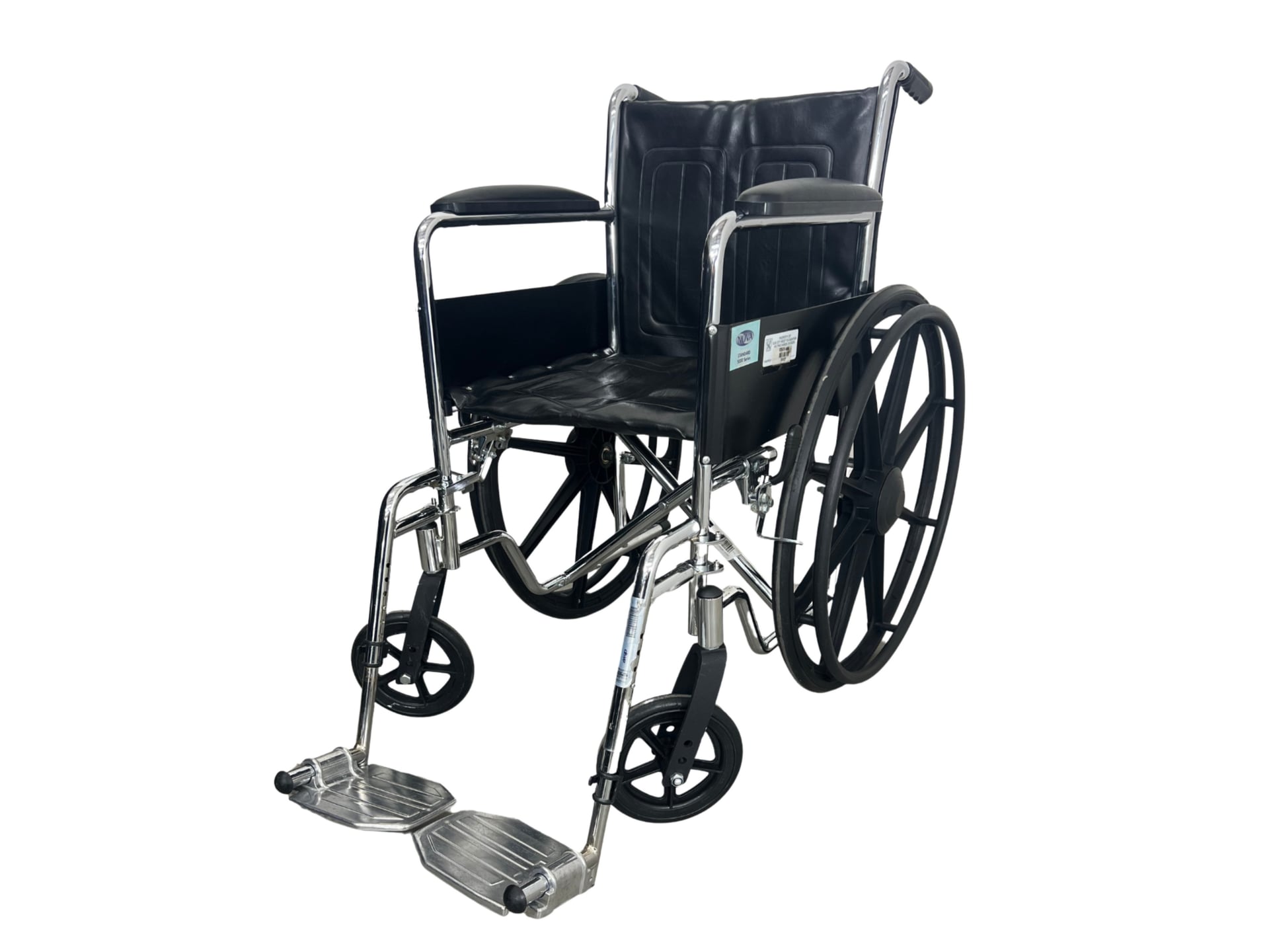 A chrome-plated steel wheelchair with a black vinyl seat and back, large rear wheels with handrims, small front swivel castors, fixed armrests, and detachable flip-up footplates.