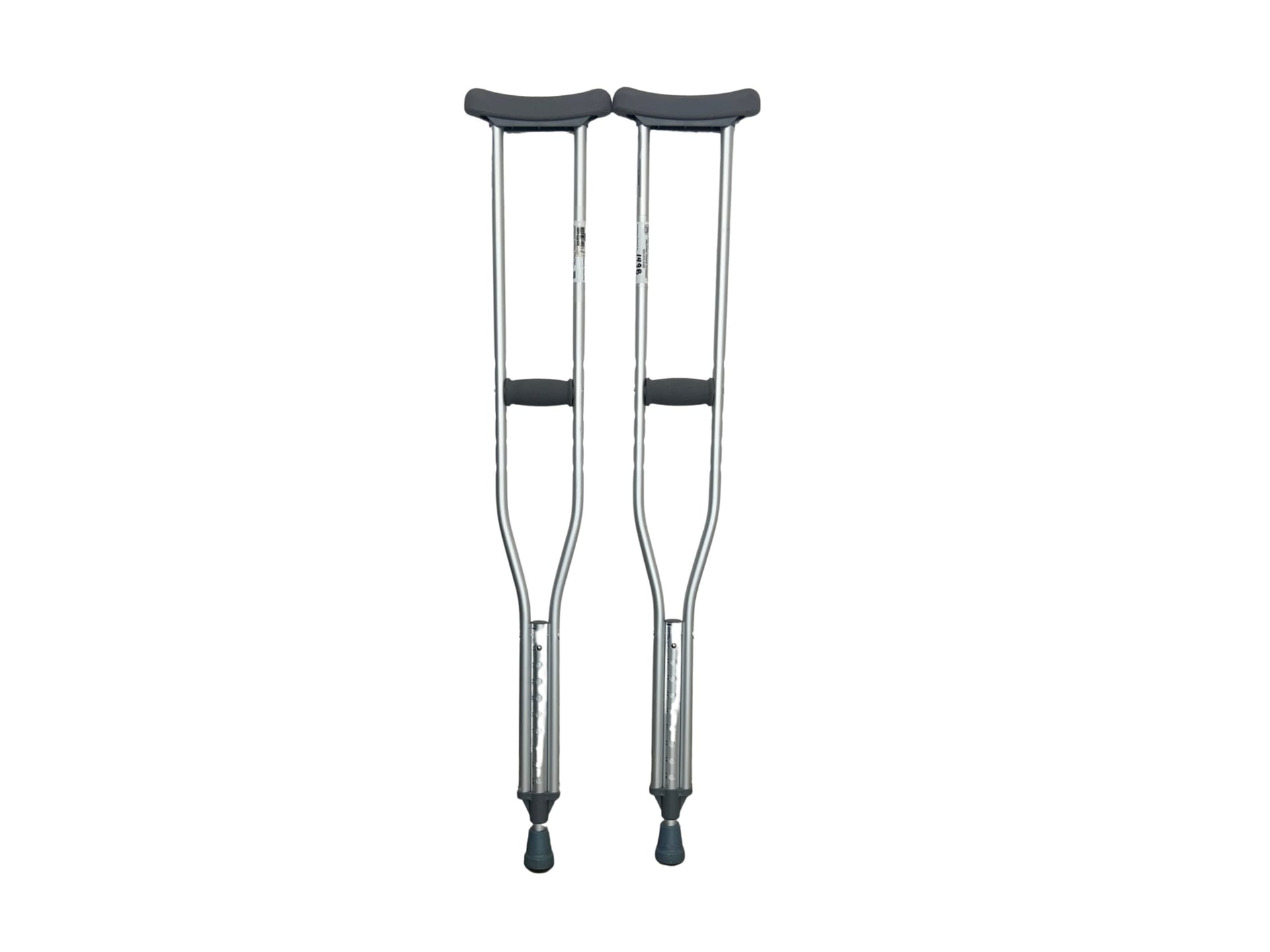 A pair of underarm crutches made from silver aluminum, each featuring a grey rubber-padded top, foam-covered handgrip, adjustable-height holes, and a rubber-tipped foot.