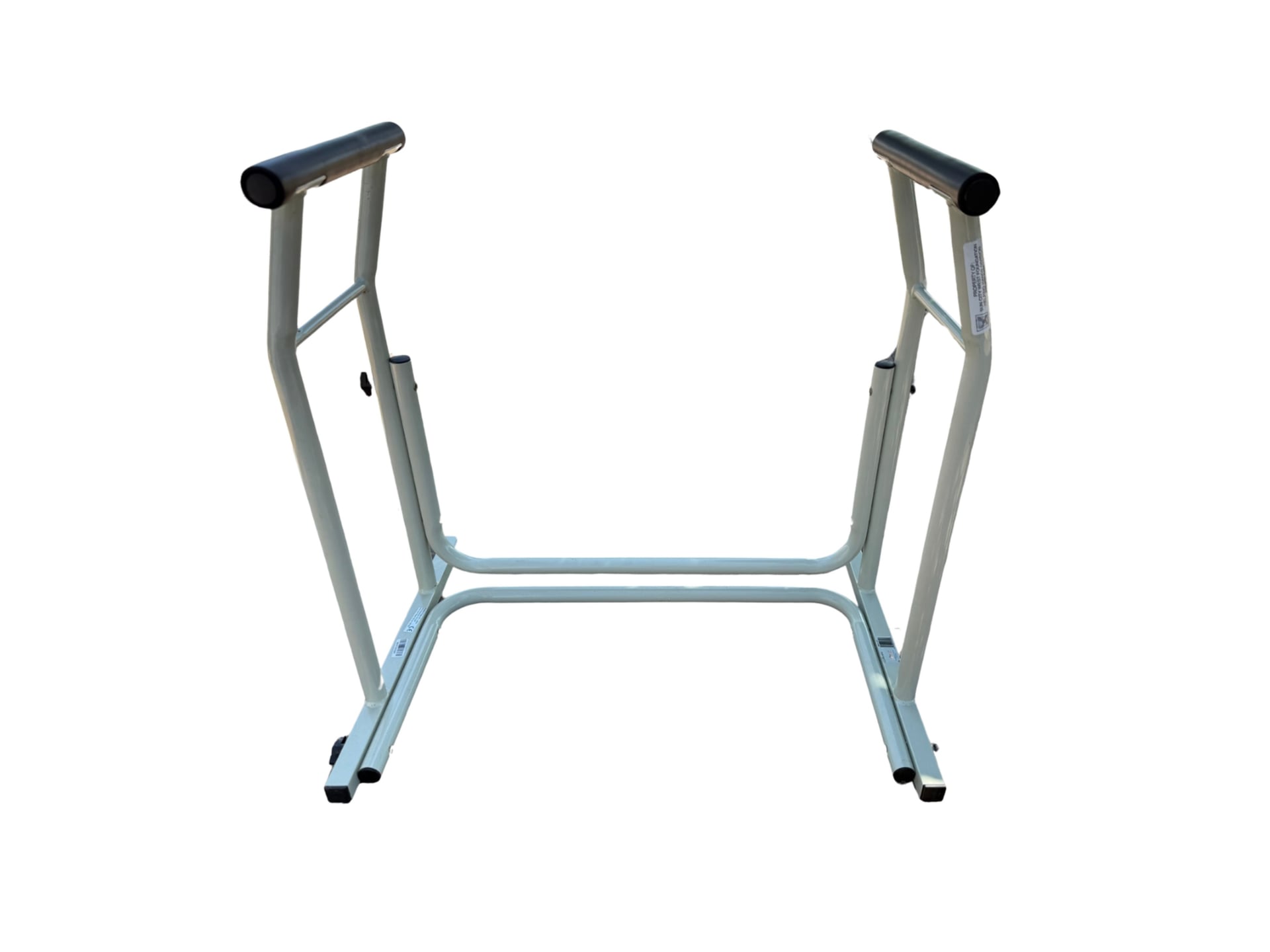 A U-shaped white-painted tubular steel frame designed to slide under a toilet bowl, featuring two vertical supports topped with padded black grips to serve as sturdy armrests.