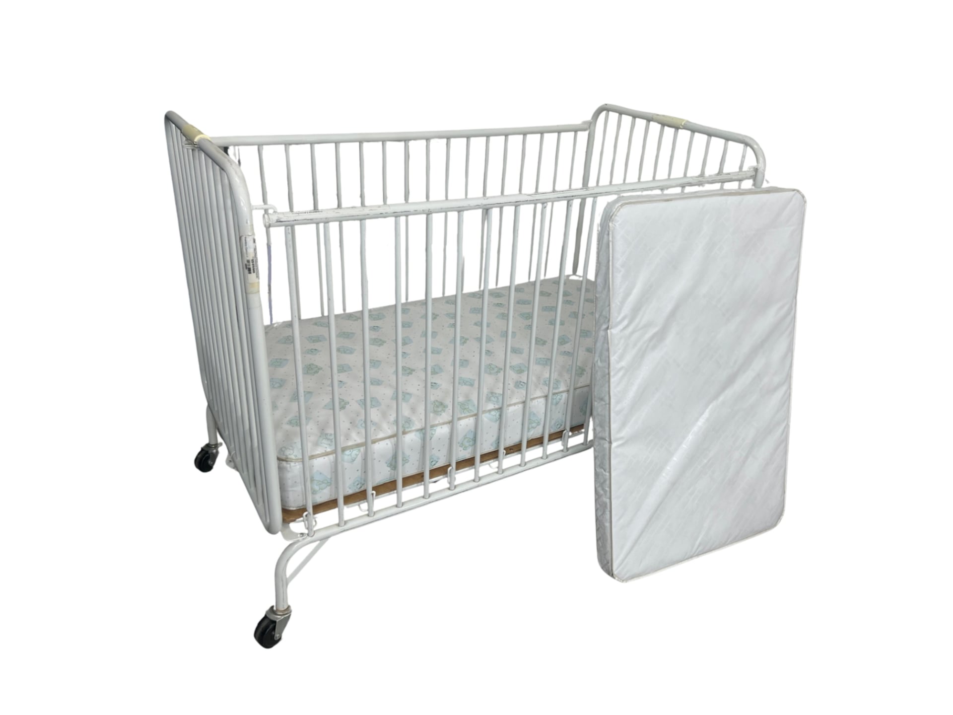 A standard-sized wooden baby crib with slatted sides, a mattress-support platform, and an adjustable height setting for the mattress.
