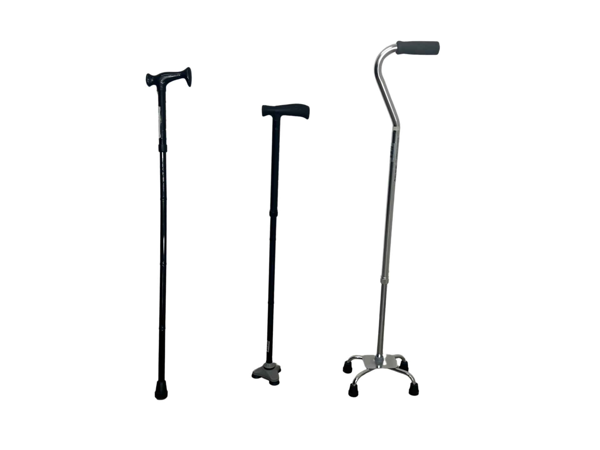 Three adjustable walking canes standing side by side: one with a single rubber tip, one with a three-point triangular rubber base, and one with a four-legged rubber base, each topped with an ergonomic handle.