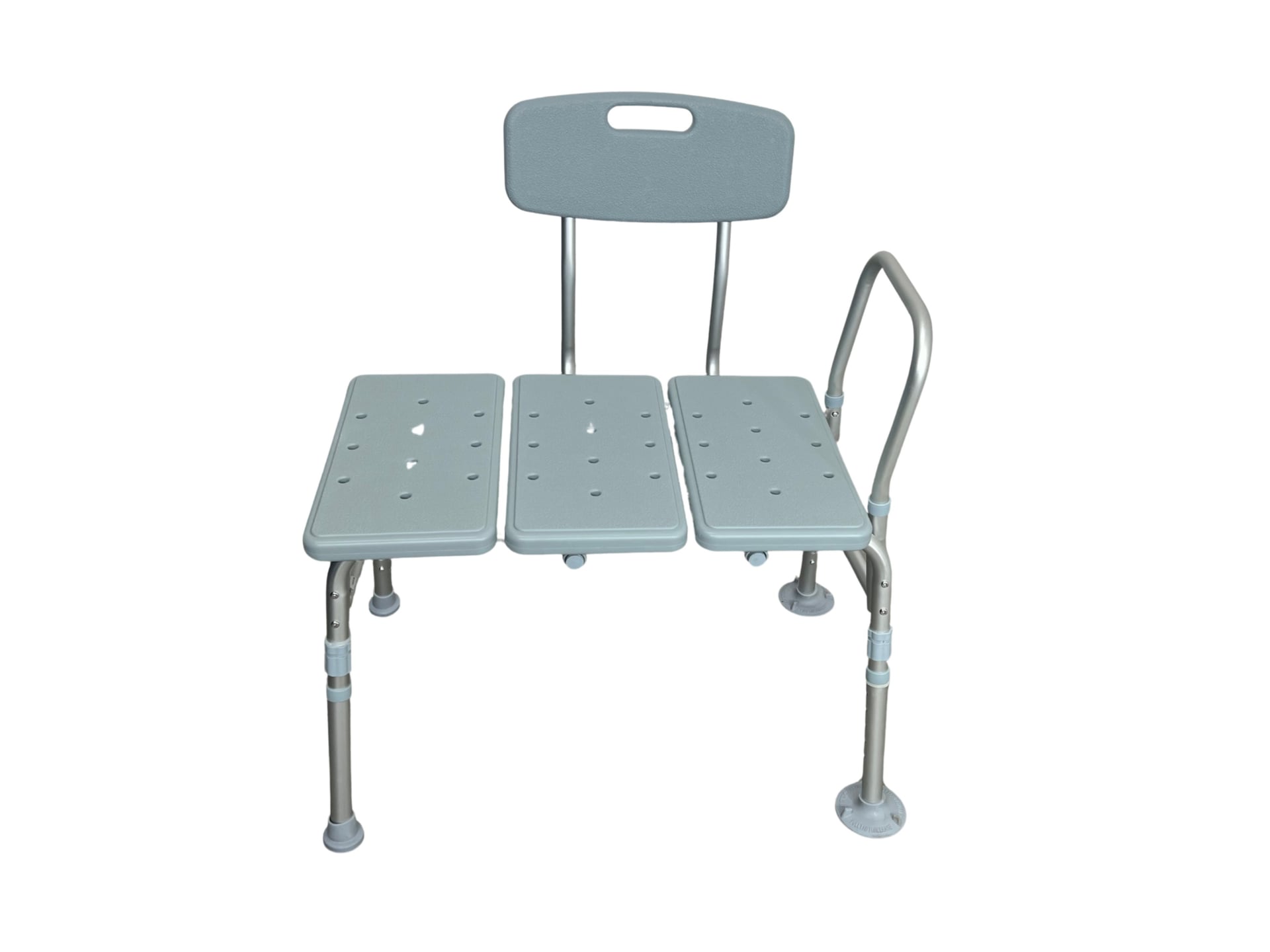 A gray plastic bath transfer bench with three perforated slats forming the seat, a backrest, a vertical side handle, and four adjustable tubular metal legs ending in rubber non-slip feet.