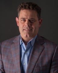 Headshot of Craig Jewett, with article discussing leadership and the work ethic behind Jewett Construction’s success.