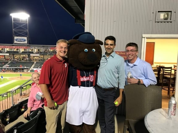 Jewett Construction employees pose with the Fisher Cats mascot during a company summer outing at the stadium.
